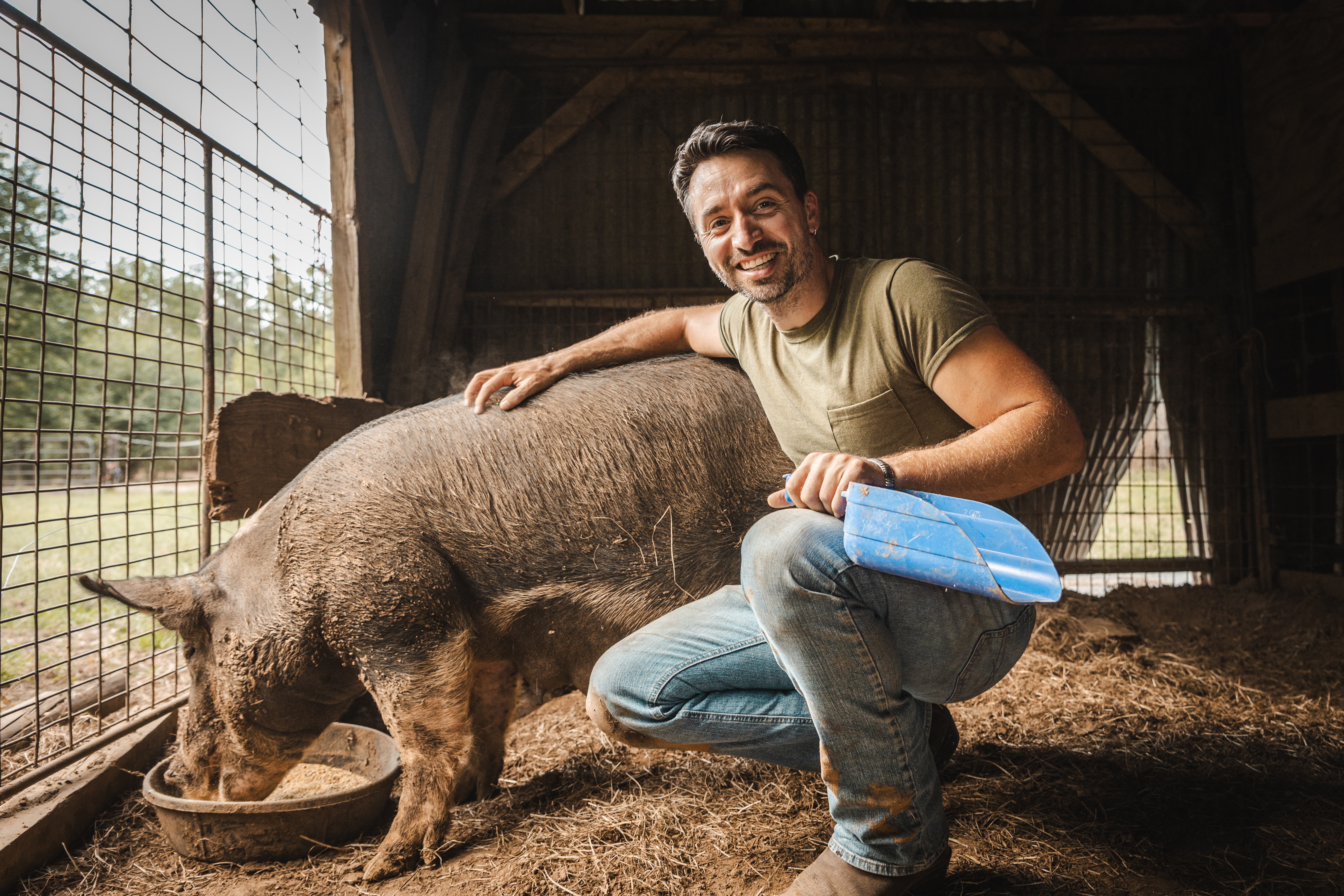 Damian with pig in the barn